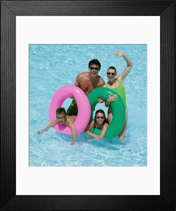 Framed Print : Father and mother with their daughter and son in a swimming pool Framed Print : Father and mother with their daughter and son in a swimming pool