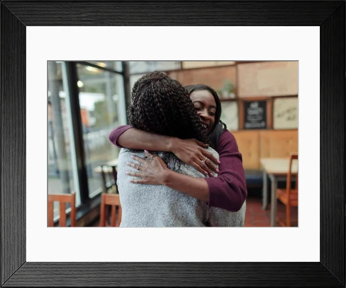 Framed Print : Happy mother and daughter hugging in cafe Framed Print : Happy mother and daughter hugging in cafe