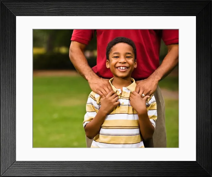 Framed Print : Father standing behind son with hands on his shoulders as boy smiles Framed Print : Father standing behind son with hands on his shoulders as boy smiles