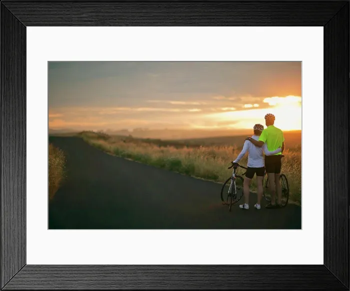 Framed Print : Mature couple embracing while watching the sunset over a rural landscape Framed Print : Mature couple embracing while watching the sunset over a rural landscape
