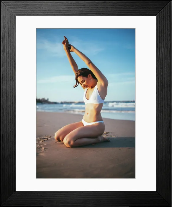 Framed Print : Side view of joyful young female tourist in swimwear sitting on knees in sunlight on sandy beach during summer vacation Framed Print : Side view of joyful young female tourist in swimwear sitting on knees in sunlight on sandy beach during summer vacation