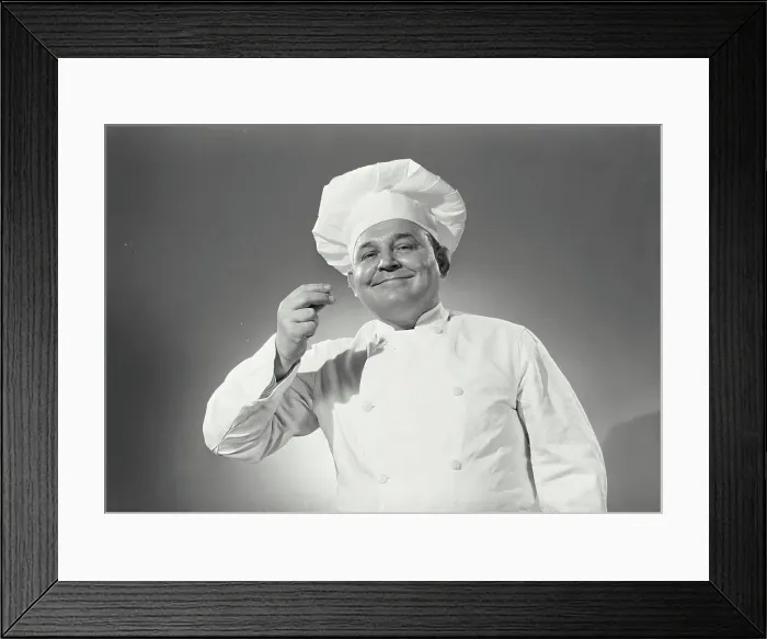Framed Print : Vintage Photograph. Man in chefs uniform tasting an imaginary spoon