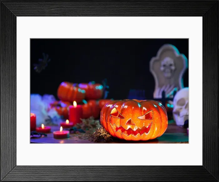 Framed Print : Haunted orange pumpking on halloween celebration table