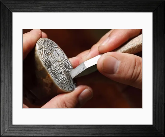Framed Print : Craftsman carving Chinese character into a Chinese chop