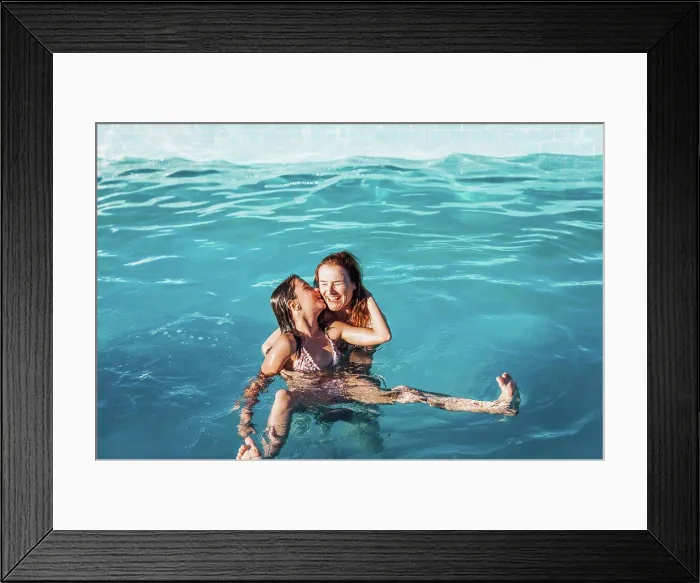 Framed Print : High angle view of girl kissing happy mother in swimming pool