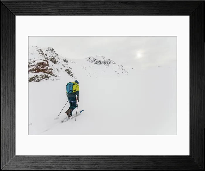 Framed Print : Rear view of man ski touring up glacier in B.C. Canada