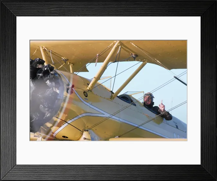 Framed Print : Vintage Photograph. Pilot in vintage biplane gives thumbs up for a thrilling open-air flight experience Framed Print : Vintage Photograph. Pilot in vintage biplane gives thumbs up for a thrilling open-air flight experience