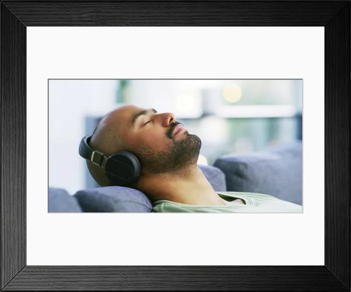 Framed Print : Relax, headphones and eyes closed with man on sofa for streaming service Framed Print : Relax, headphones and eyes closed with man on sofa for streaming service