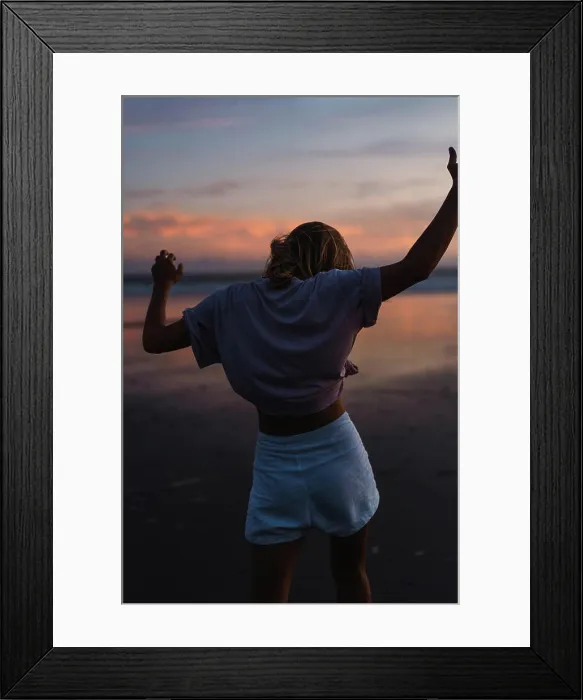 Framed Print : Young woman dancing at sunset on a tropical beach in Bali Framed Print : Young woman dancing at sunset on a tropical beach in Bali