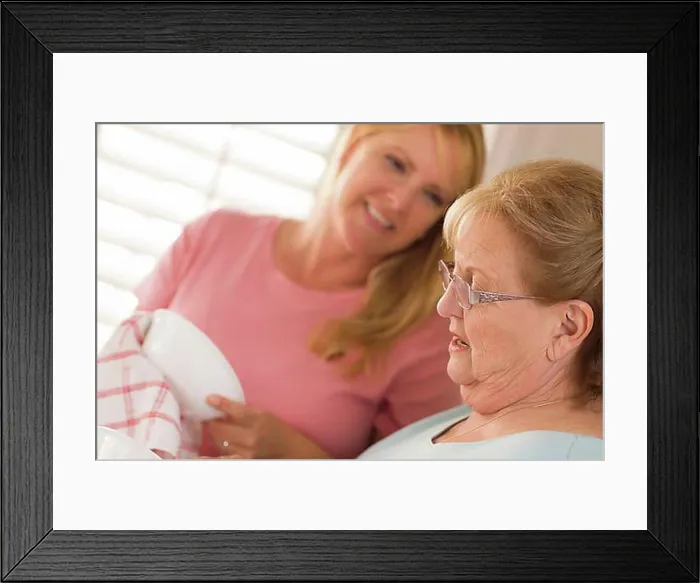 Framed Print : Smiling senior adult woman and young daughter talking at sink in kitchen Framed Print : Smiling senior adult woman and young daughter talking at sink in kitchen