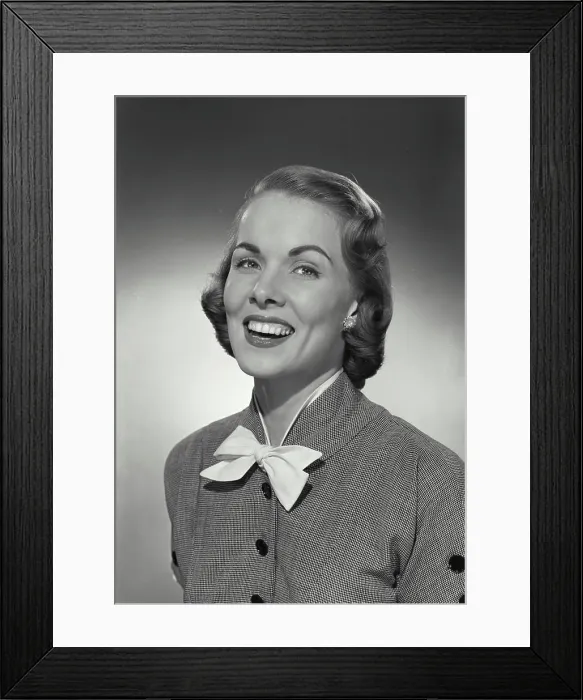 Framed Print : Vintage photograph. Woman in button blouse with bow smiling at camera Framed Print : Vintage photograph. Woman in button blouse with bow smiling at camera