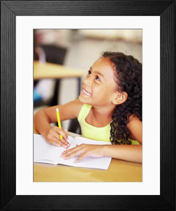 Framed Print : Happy, school and child writing in her book while listening to a lesson in the classroom Framed Print : Happy, school and child writing in her book while listening to a lesson in the classroom