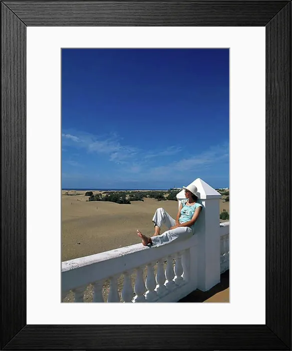 Framed Print : Woman sitting on a balustrade, railing of the RIU Palace Hotel Framed Print : Woman sitting on a balustrade, railing of the RIU Palace Hotel