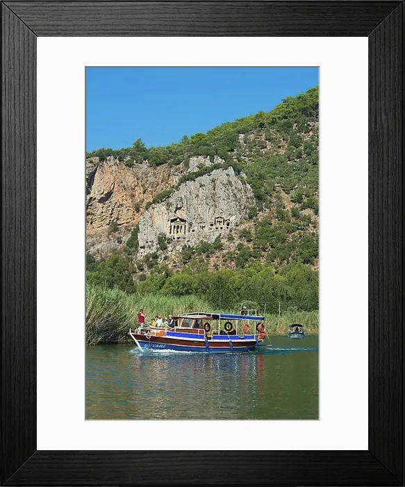 Framed Print : Excursion boats on the Dalyan river in front of the rock tombs of Caunos or Kaunos near Marmaris Framed Print : Excursion boats on the Dalyan river in front of the rock tombs of Caunos or Kaunos near Marmaris