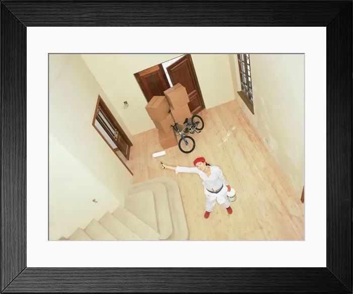 Framed Print : Woman with roller in new home