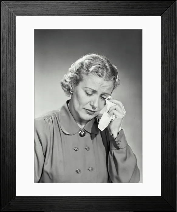 Framed Print : Vintage photograph. Woman in button coat wiping tears with handkerchief Framed Print : Vintage photograph. Woman in button coat wiping tears with handkerchief