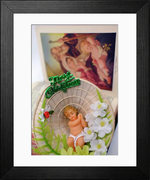 Framed Print : Nativity scene. Baby Jesus in a conical hat and holy bible Framed Print : Nativity scene. Baby Jesus in a conical hat and holy bible