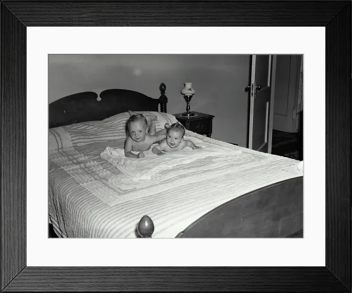 Framed Print : Vintage Photograph. Two babies laying on their stomach on a bed Framed Print : Vintage Photograph. Two babies laying on their stomach on a bed