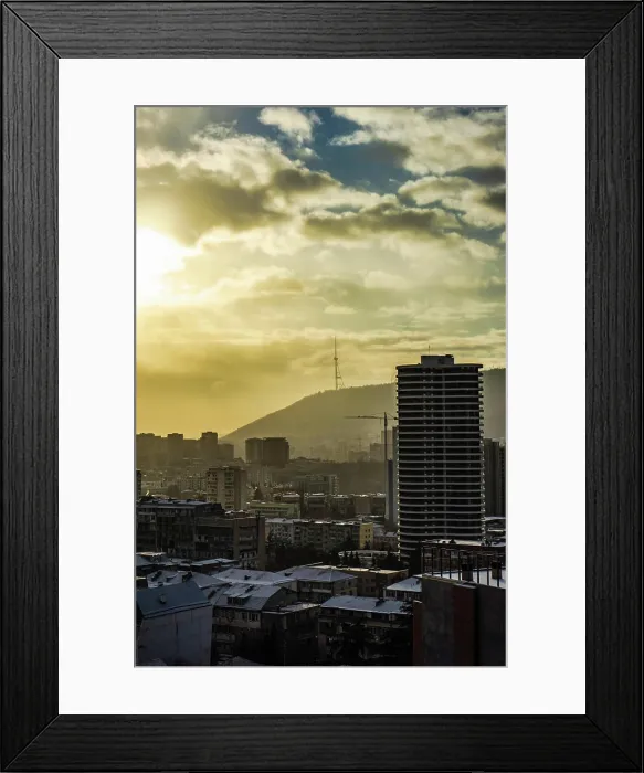 Framed Print : Dramatic sky over Tbilisi city Dramatic sky over Tbilisi citys downtown in winter with sun rays and snow Copyright