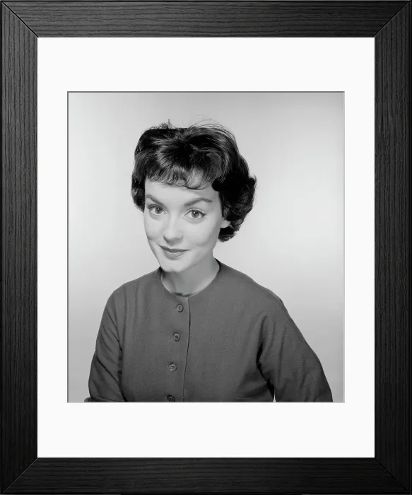 Framed Print : Studio portrait of young woman smiling Framed Print : Studio portrait of young woman smiling