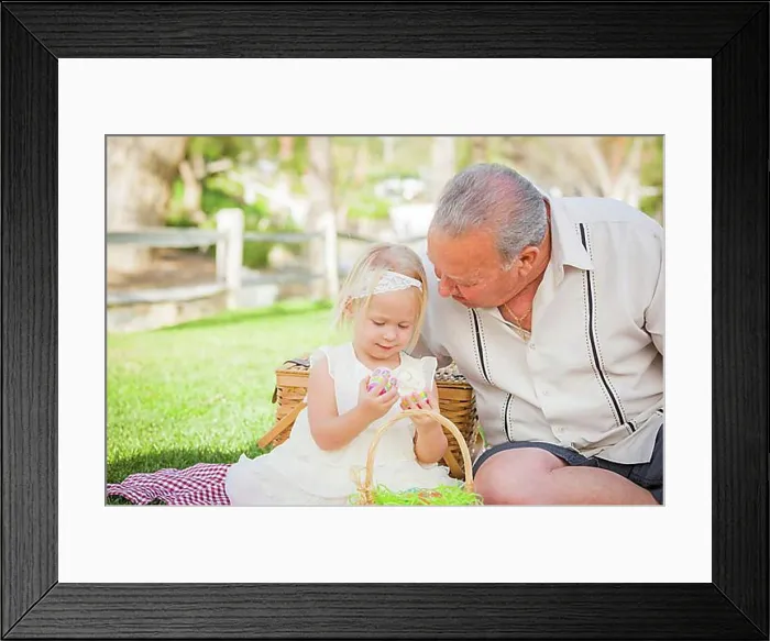 Framed Print : Loving grandfather and granddaughter enjoying easter eggs on a picnic blanket at park Framed Print : Loving grandfather and granddaughter enjoying easter eggs on a picnic blanket at park