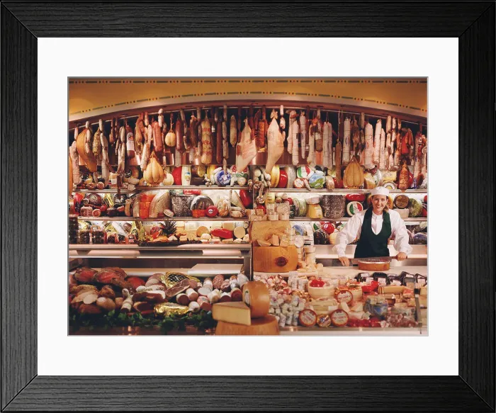 Framed Print : Associate in Chefs hat at deli counter with large selection of imported meats and cheeses Framed Print : Associate in Chefs hat at deli counter with large selection of imported meats and cheeses