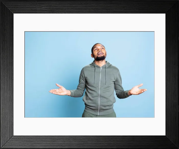 Framed Print : Young religious adult worshipping God for peace and love in studio Framed Print : Young religious adult worshipping God for peace and love in studio