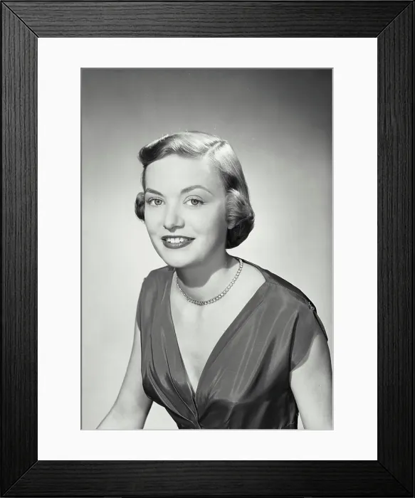 Framed Print : Vintage photograph. Woman in v-cut dress smiling at camera Framed Print : Vintage photograph. Woman in v-cut dress smiling at camera