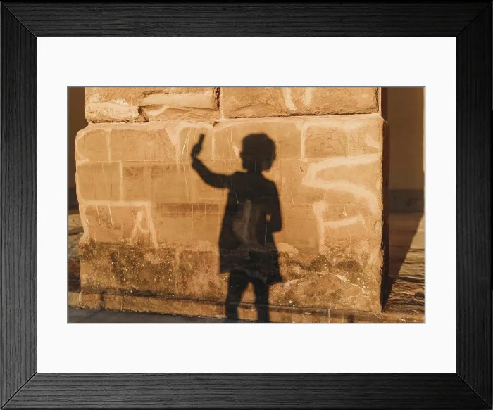 Framed Print : Shadow of woman taking selfie on stone wall Framed Print : Shadow of woman taking selfie on stone wall