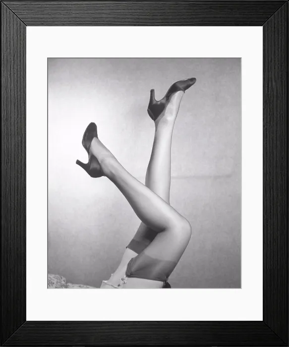 Framed Print : Nylon stockings in the 1940s. A young woman's legs with nylon stockings that fit perfectly is the latest fashion