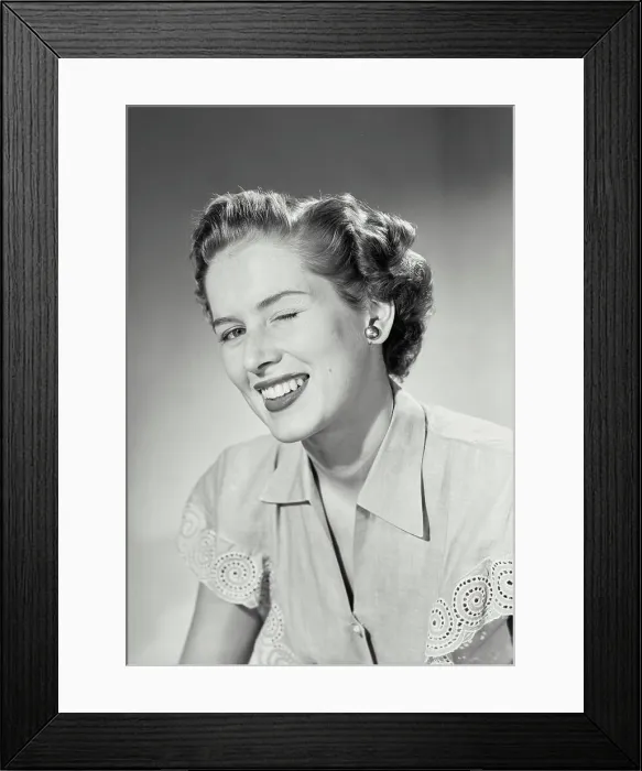 Framed Print : Vintage photograph. Woman in collared blouse winking at camera