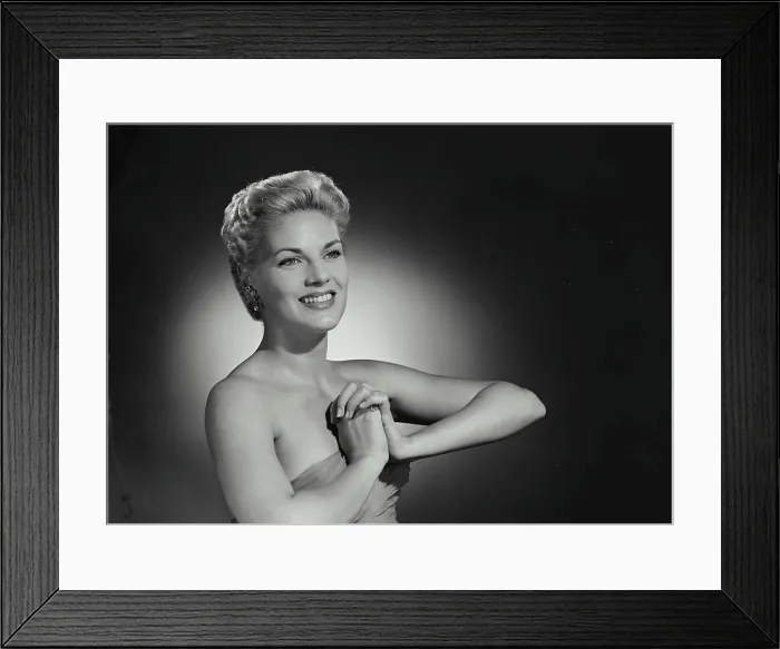 Framed Print : Vintage Photograph. Smiling blonde woman with hair up and low cut gown clasping hands together in front of chest