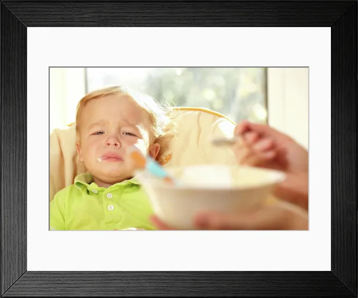 Framed Print : Kid is very disappointmented about porridge