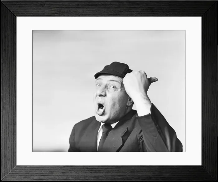 Framed Print : Man in suit and cap making a funny surprised expression with hand gesture Framed Print : Man in suit and cap making a funny surprised expression with hand gesture