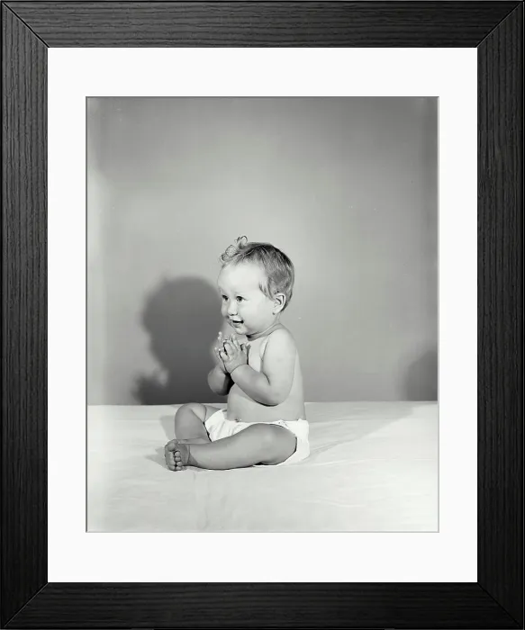 Framed Print : Vintage Photograph. Baby clapping hands and looking to the left of frame