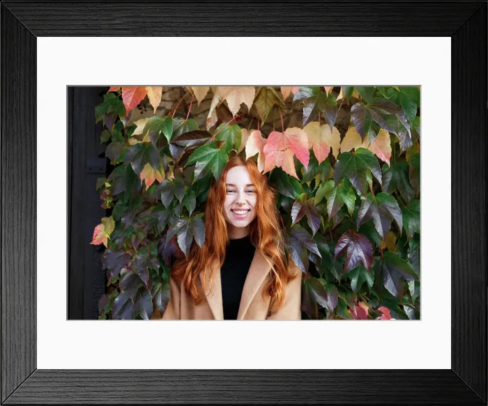 Framed Print : young stylish red-haired woman on the background of green leaves Framed Print : young stylish red-haired woman on the background of green leaves