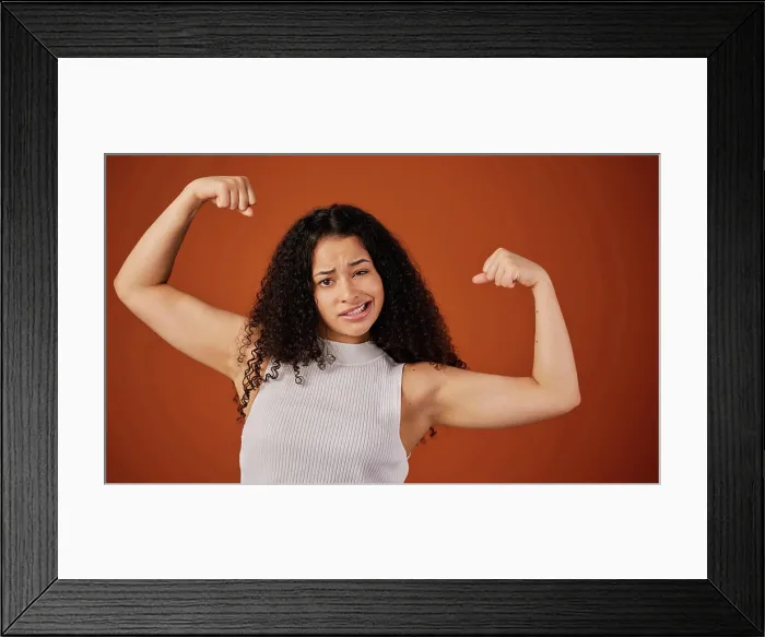 Framed Print : Bicep, flex and portrait of powerful woman in studio isolated on brown background for girl power Framed Print : Bicep, flex and portrait of powerful woman in studio isolated on brown background for girl power