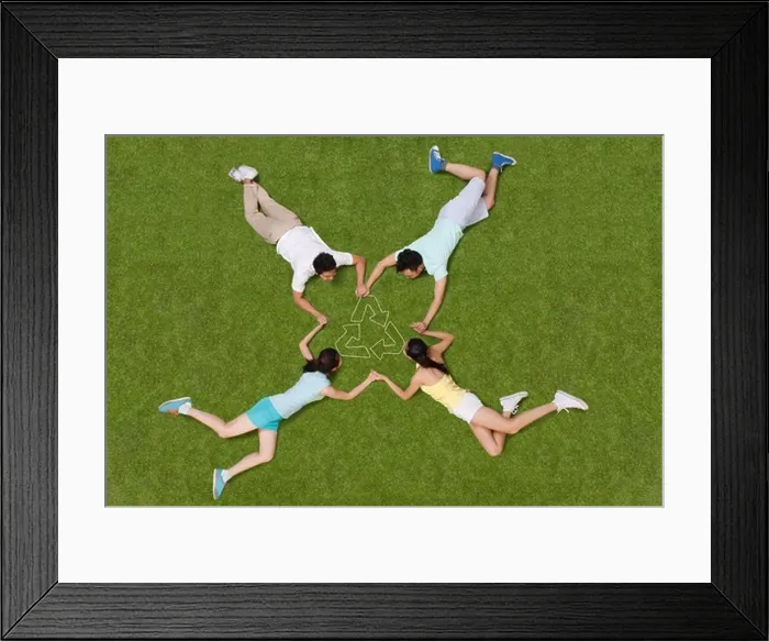 Framed Print : Young people lying on grass hand in hand Framed Print : Young people lying on grass hand in hand