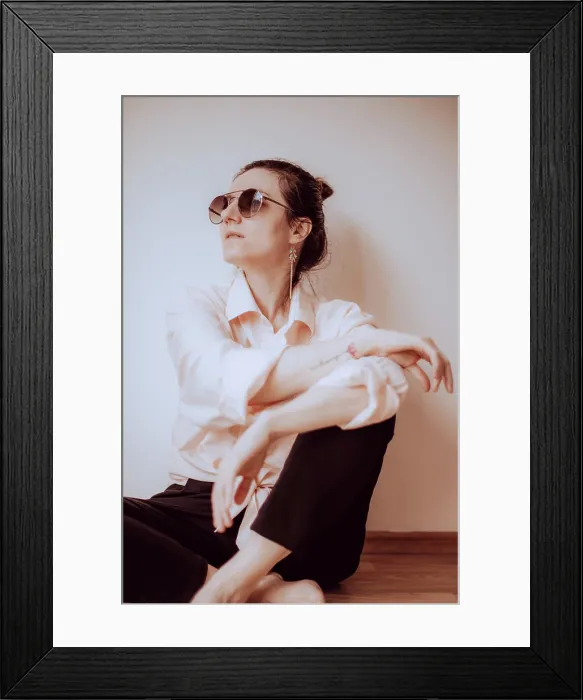 Framed Print : Modern woman in minimalist style sitting indoors Framed Print : Modern woman in minimalist style sitting indoors