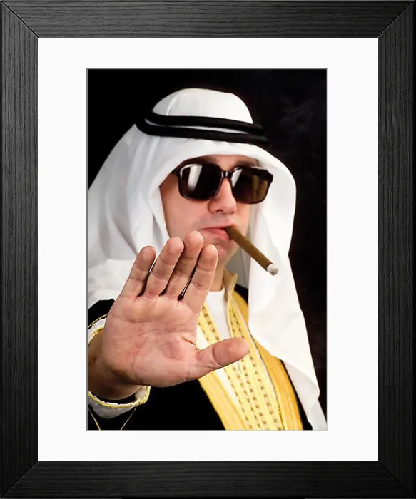 Framed Print : Man wearing a Sheikh costume and smoking a cigar