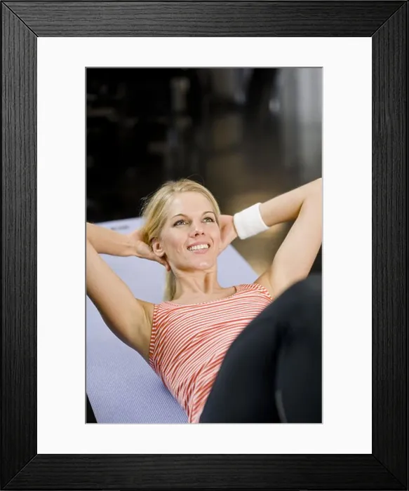 Framed Print : A woman doing sit-ups at a gym, Sweden Framed Print : A woman doing sit-ups at a gym, Sweden