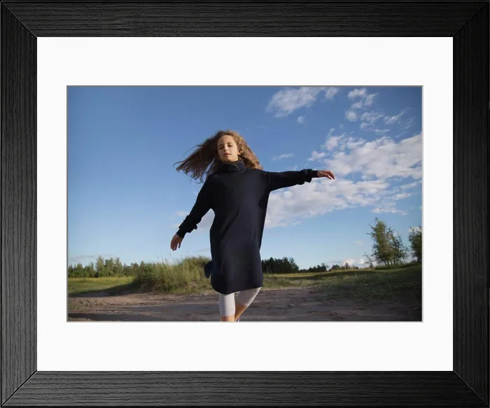 Framed Print : A girl with long hair is spinning close-up Framed Print : A girl with long hair is spinning close-up