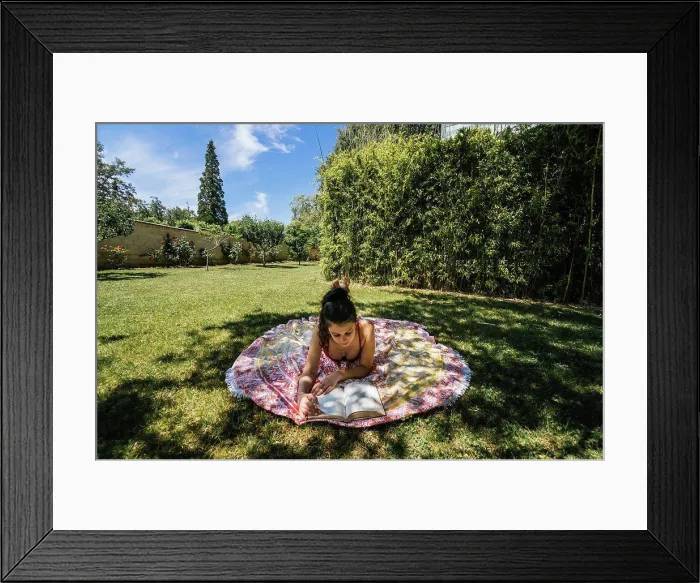 Framed Print : woman reading on a towel in the garden with swimsuit under a tree Framed Print : woman reading on a towel in the garden with swimsuit under a tree