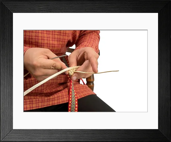 Framed Print : Wickerwork. Studio photo of craftsman makes basket, close-up