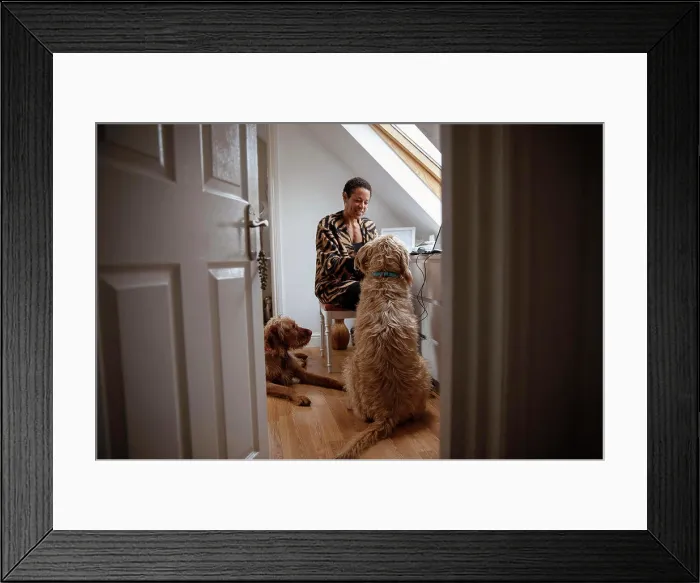 Framed Print : Dogs watching woman working from home in home office doorway Framed Print : Dogs watching woman working from home in home office doorway