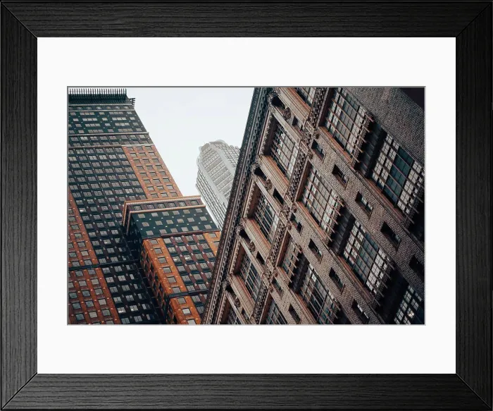 Framed Print : Two brick high rise buildings in Manhattan in front of a skyscraper on a foggy morning Framed Print : Two brick high rise buildings in Manhattan in front of a skyscraper on a foggy morning