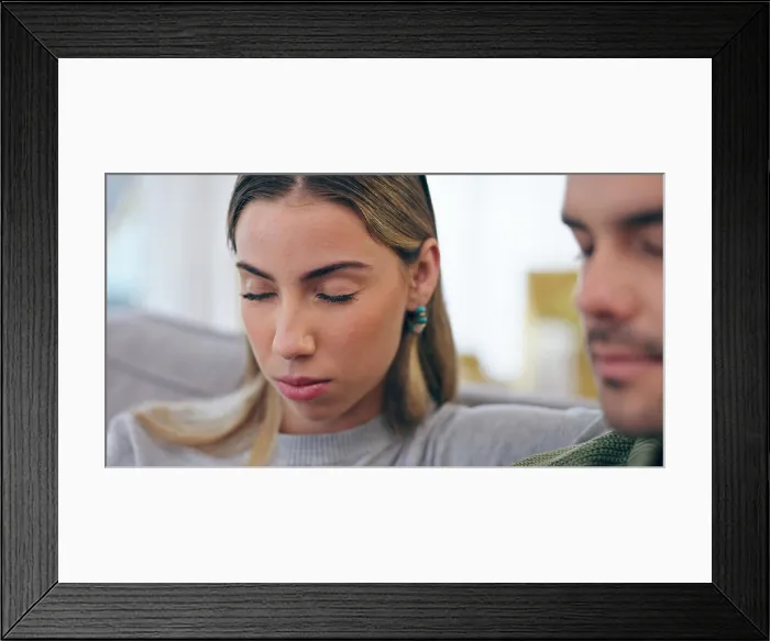 Framed Print : Face, prayer and a young couple on a sofa in the living room of their home for belief or religion together Framed Print : Face, prayer and a young couple on a sofa in the living room of their home for belief or religion together