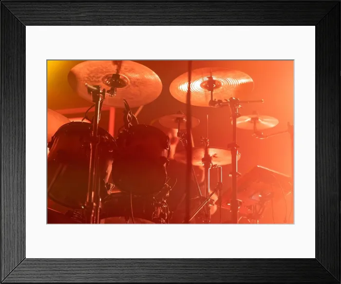 Framed Print : A close-up of a drum set in colorful lighting