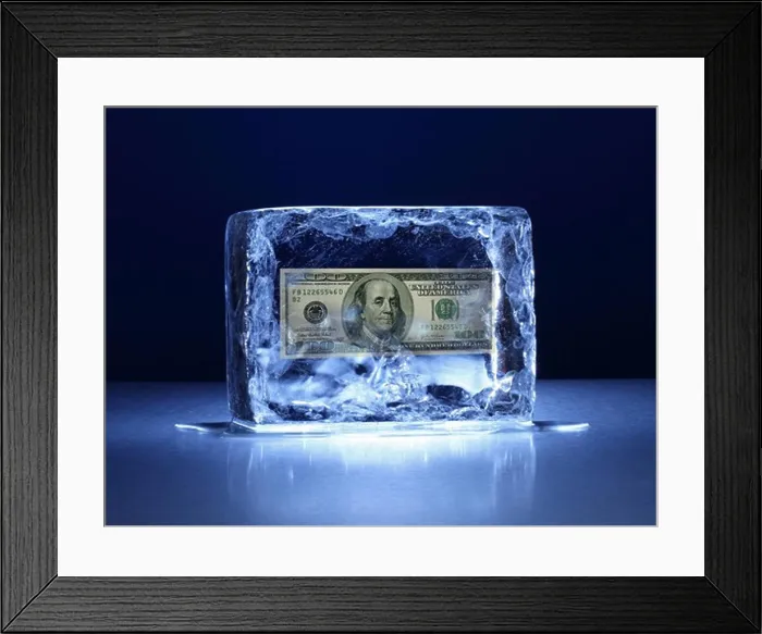 Framed Print : Large block of ice with one hundred dollar bill frozen inside Framed Print : Large block of ice with one hundred dollar bill frozen inside