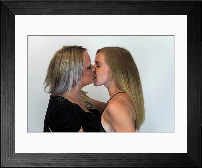 Framed Print : A gay couple show their love for each other in a studio environment